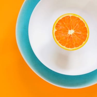 half an orange on a plate
