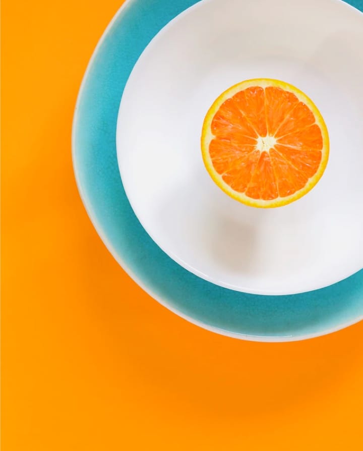 half an orange on a plate
